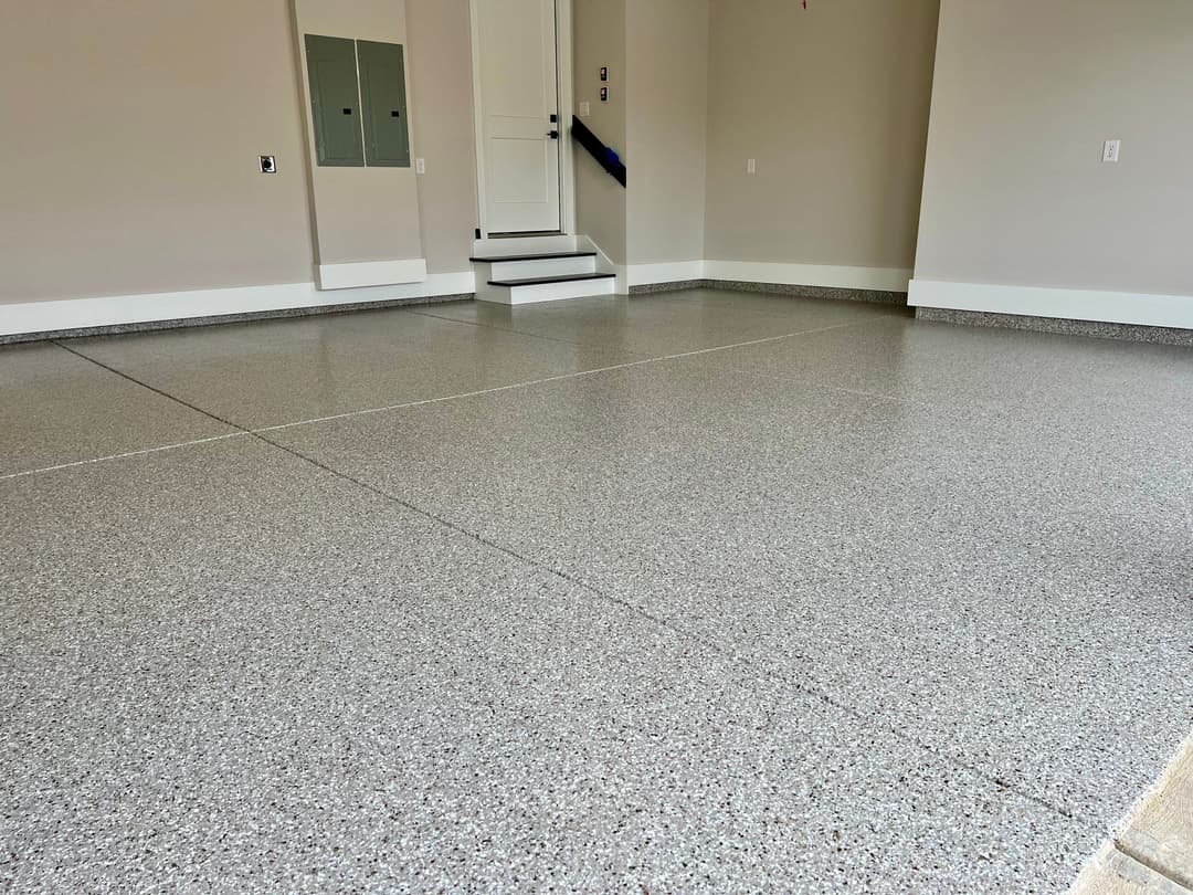 Clean and polished garage floor with epoxy coating and neutral wall color.