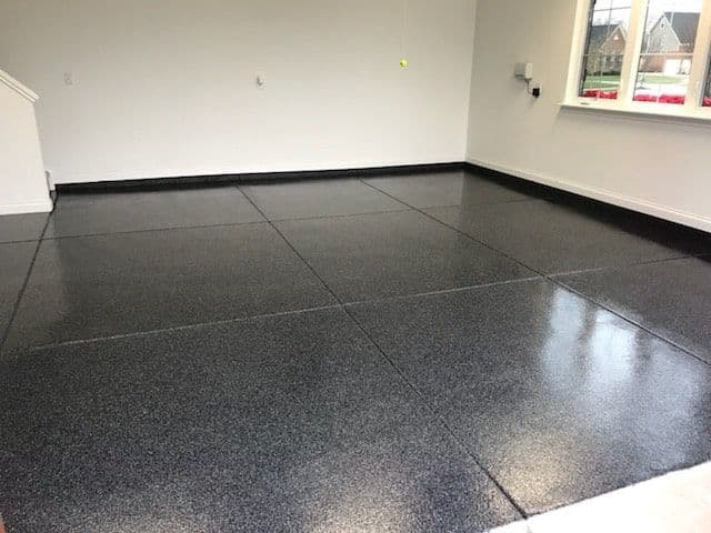 Shiny black epoxy-coated garage floor with smooth, modern finish.