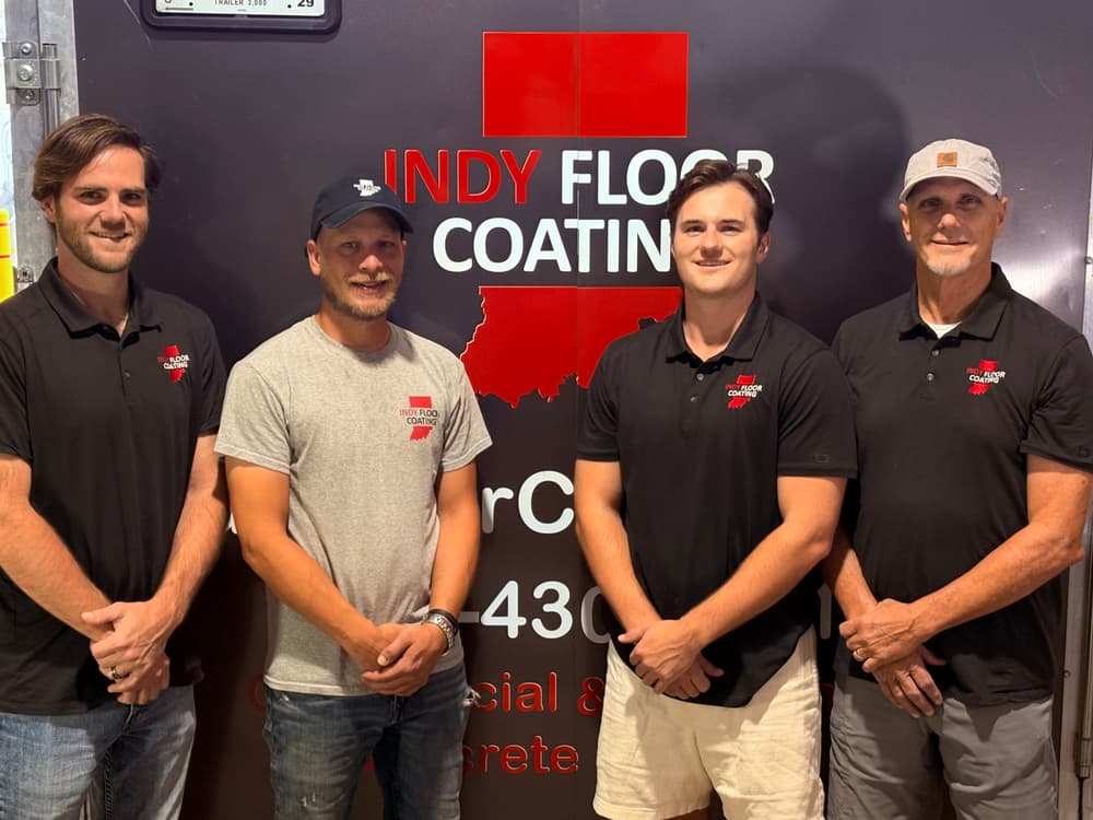 Team of professionals from Indy Floor Coating standing in front of their branded truck.
